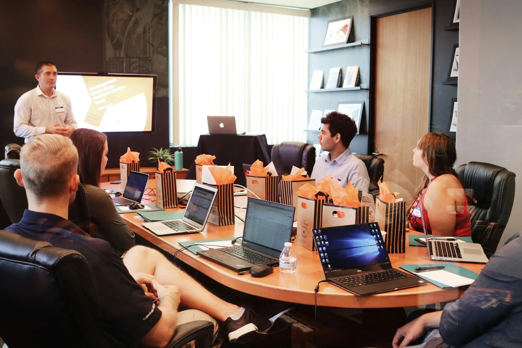A presentation to a team gathered around a table